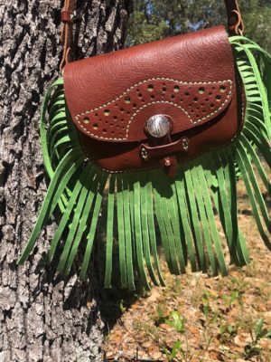 Saddlebag style leather purse with green fringe